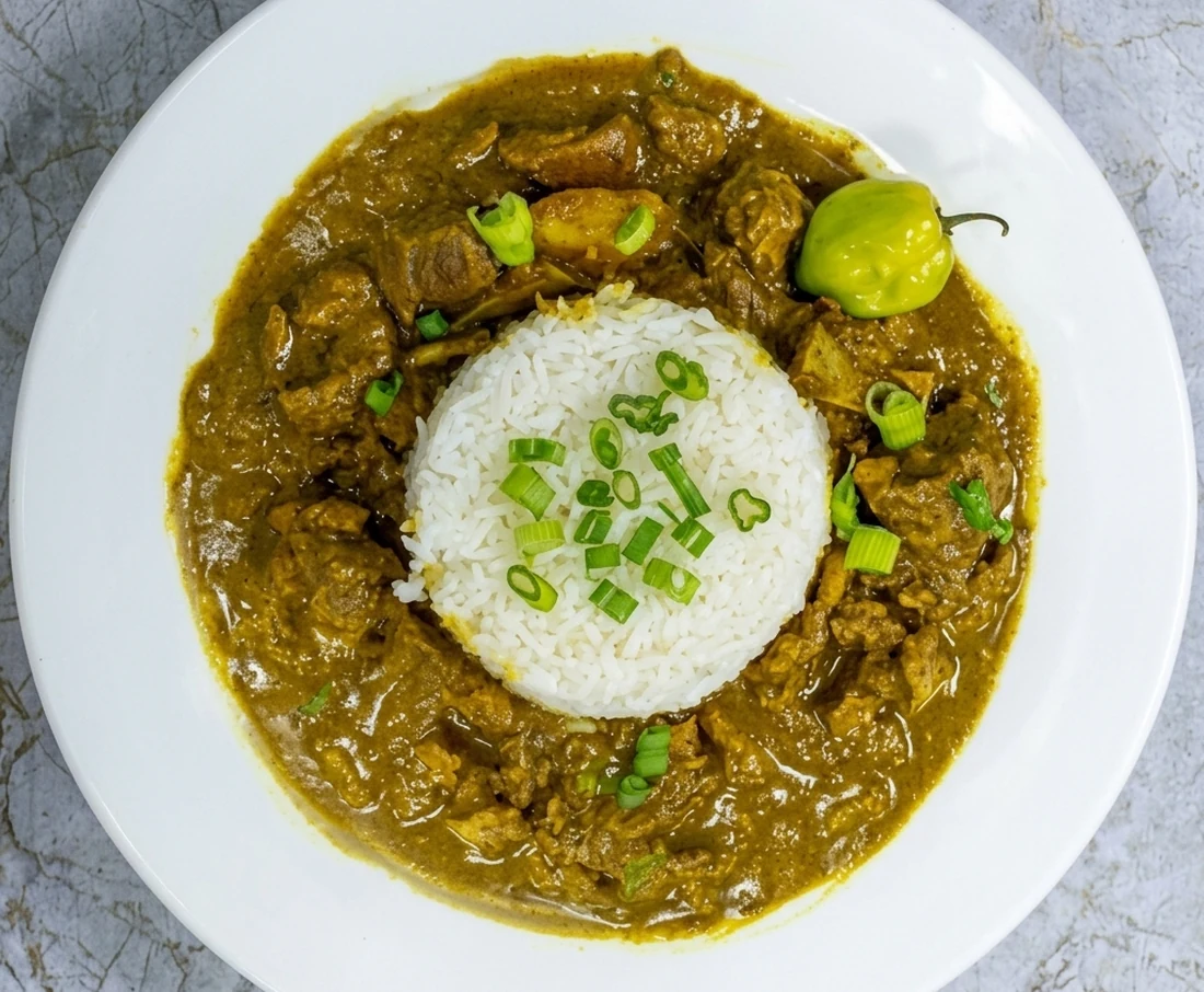 Authentic Caribbean curry goat plate at Twin Dem Kitchen on Jalna Blvd London