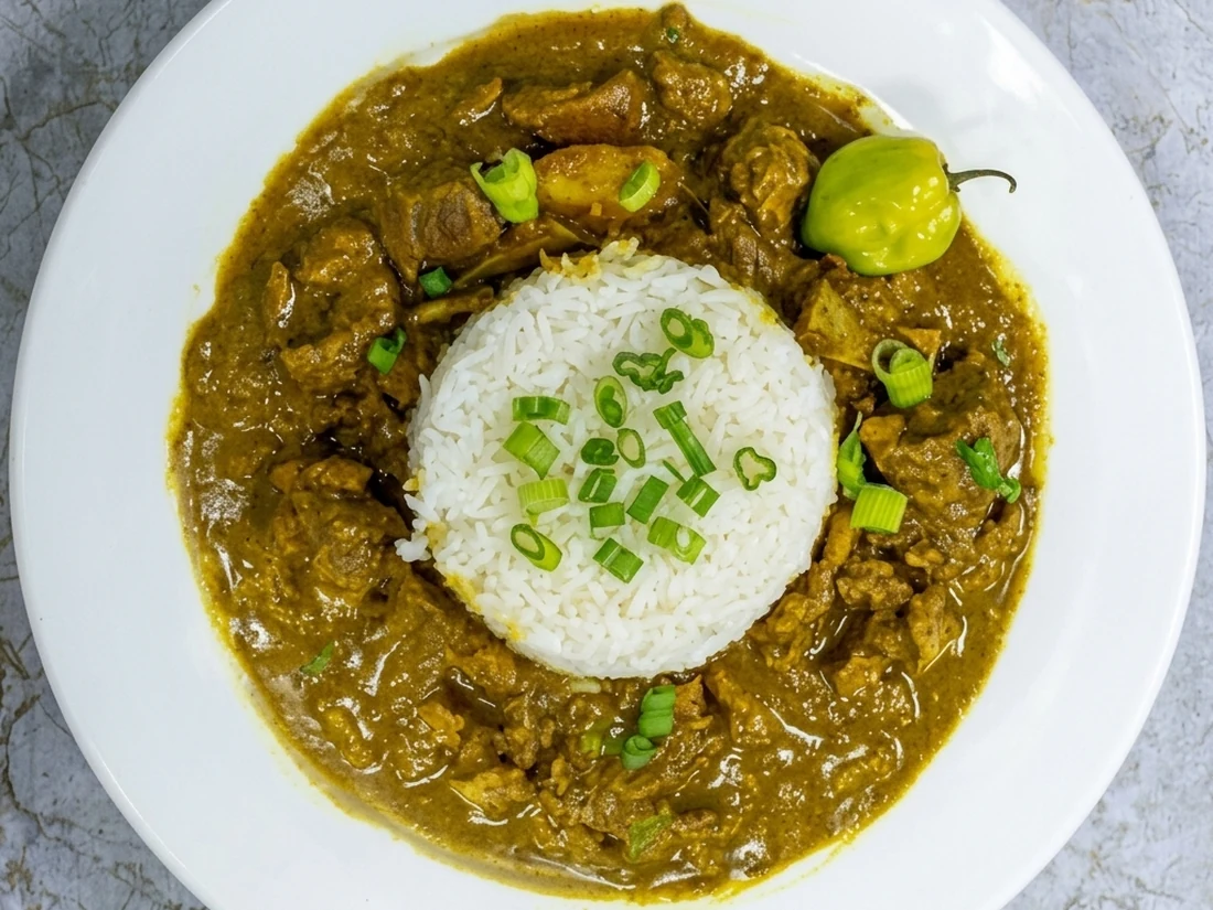 Curry goat with rice and peas at Twin Dem Kitchen London Ontario